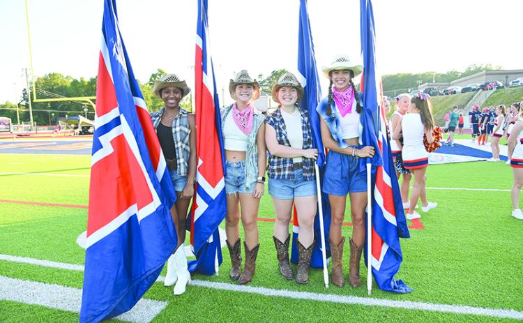 From left, Amayah Dooley, Maggie Vena, Brooke Blackburn and Kyia Barrett helped carry the flags when the Raiders ran out on the field for the season opener against Stephens County. TOM ASKEW/Special