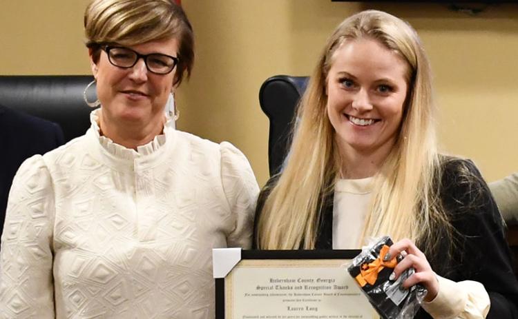 Lauren Long (right), shown being honored by County Manager Alicia Vaughn last year, has been writing grants for the county for 15 months. FILE 