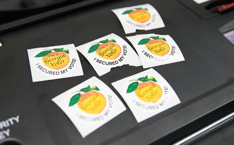 Various election stickers are shown Tuesday waiting for their chance to show off their bearer’s civic pride. ZACH TAYLOR/Special