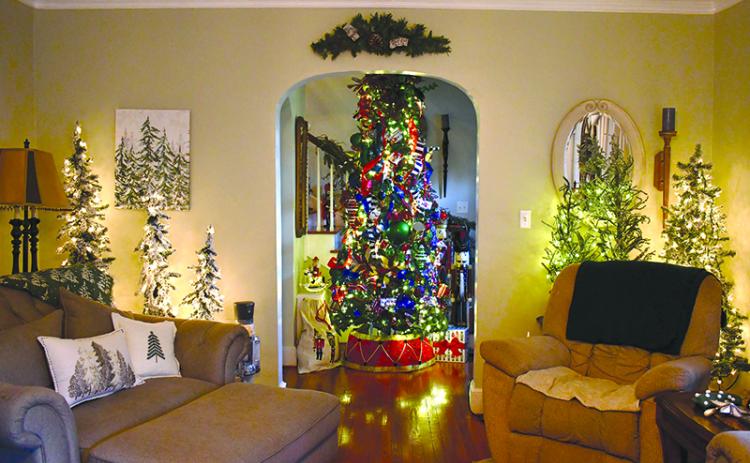 Teri Newsome’s Cornelia home is  as festive as can be, sporting 33  Christmas trees and plenty of  other holiday delights. JULIANNE AKERS/Staff