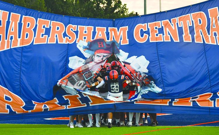 Habersham Central’s football team is led out by Andru Kinnarath. LANG STOREY/Staff
