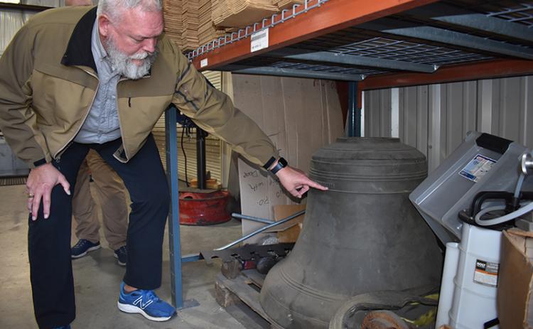 Sheriff Joey Terrell points out the  features of the old courthouse bell that dates to 1924. MATTHEW OSBORNE/Staff