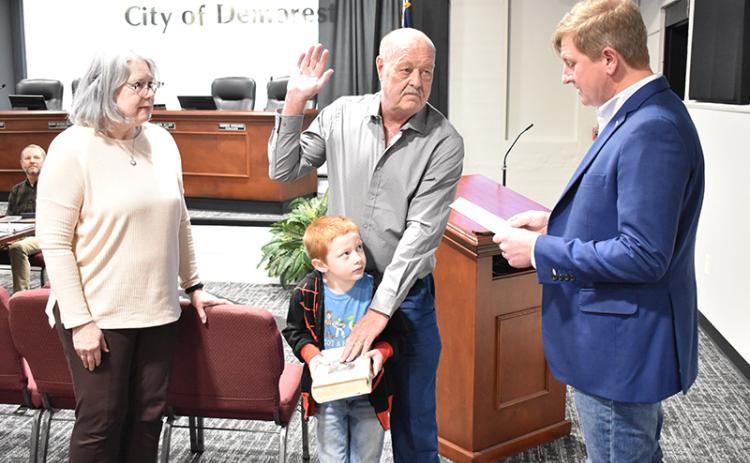 Demorest Councilman Jimmy Davis is sworn in Tuesday by Mayor Jerry Harkness for his first term on the council along with his wife Patti and great grandson Carter Willis. MATTHEW OSBORNE/Staff