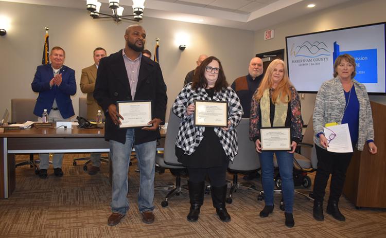 Habersham County Senior Center care provider Joshua Haynie and employees Sonya Turgeon and Laureen Pemberton were honored Tuesday night by Senior Center Director Kathy Holcomb (right) and the Board of Commissioners for their recent heroism in three crises. MATTHEW OSBORNE/Staff