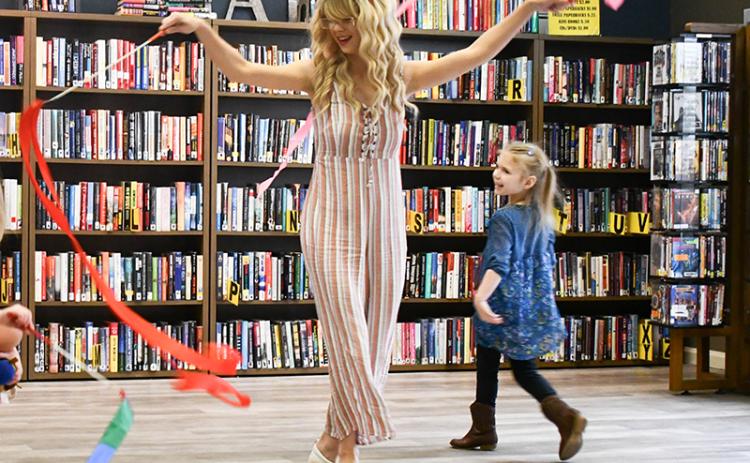 Magic Movements and Music Class Instructor Alexis Lowe, left, twirls ribbons with her daughter Stacy Grace Wratchford, right. JULIANNE AKERS/Staff