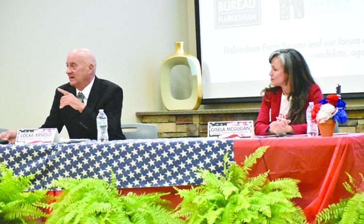 District 5 challengers Locke Arnold (left) and Gisela McGugan participate in the Farm Bureau political forum on Tuesday night.