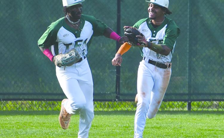 Tallulah Falls’ Danny Grant and BJ Carver dap each other up after an inning-ending catch by the former.