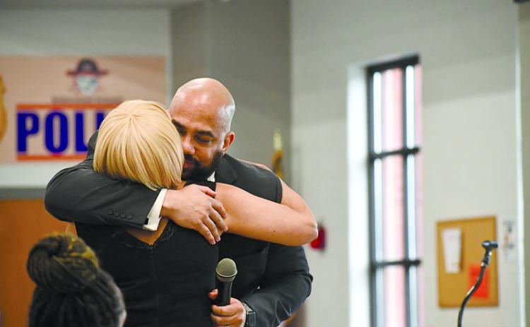 Dr. Aaron Scott and his mother, Sheree Parrish, of Cornelia, embrace at the 2024 Lifetime Achievement Award ceremony. JULIANNE AKERS/Staff